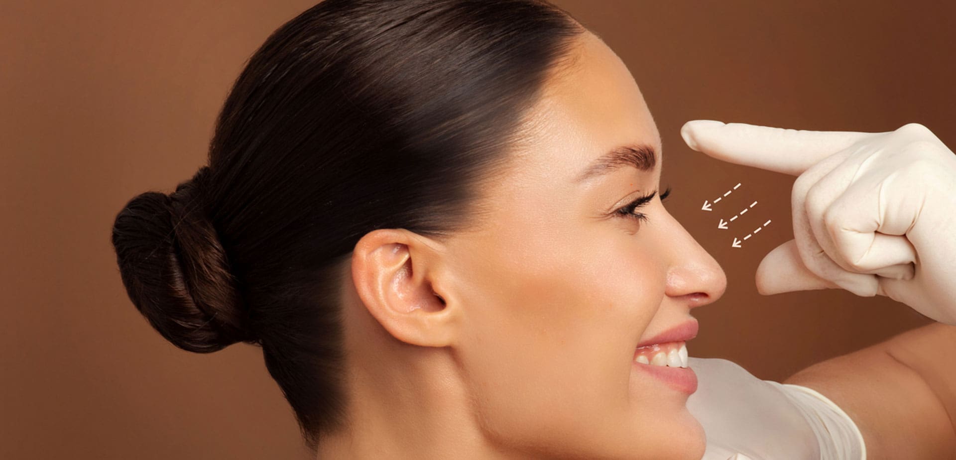 gloved-provider-examining-a-woman's-profile-and-nose